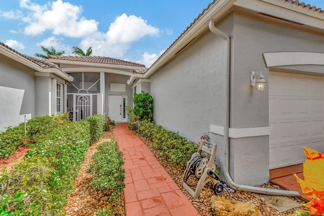 doorway to property with a garage