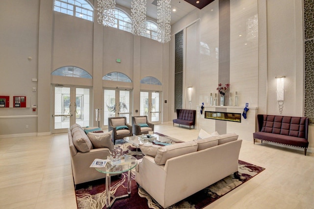 living room featuring a towering ceiling and french doors