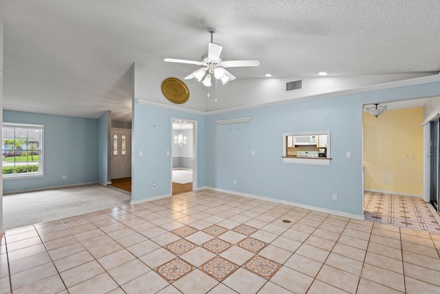 tiled spare room with ceiling fan, a textured ceiling, crown molding, and vaulted ceiling