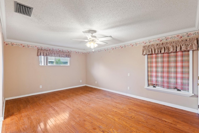 unfurnished room featuring ornamental molding, a textured ceiling, hardwood / wood-style flooring, and ceiling fan