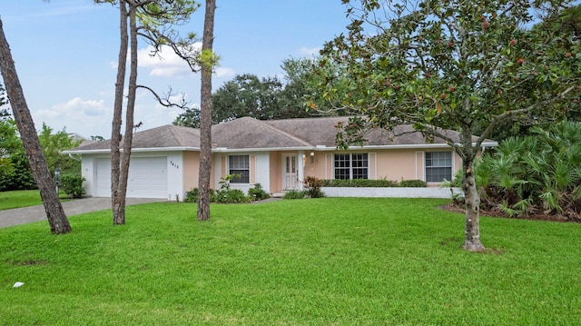 single story home with a garage and a front lawn