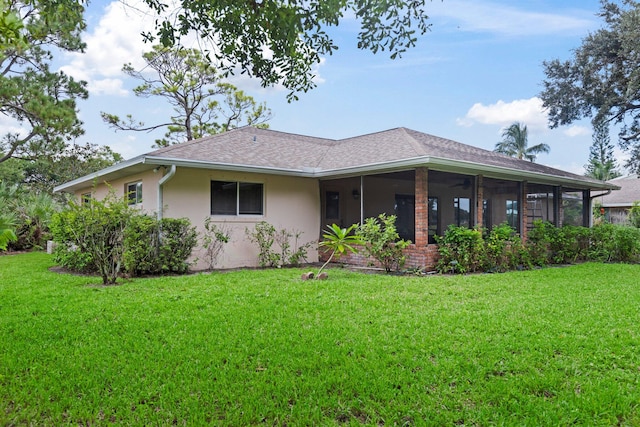 back of property featuring a lawn