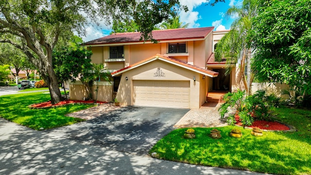 view of front of property with a garage and a front lawn