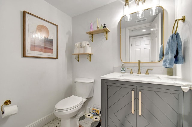 bathroom featuring tile patterned floors, vanity, and toilet