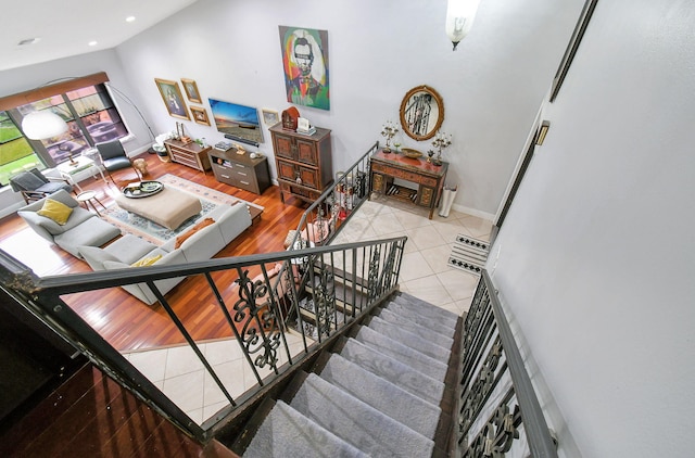 stairs with wood-type flooring and lofted ceiling