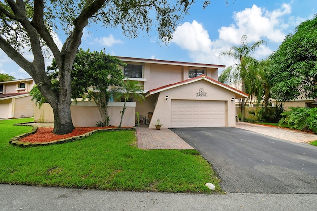 view of front facade with a front yard and a garage