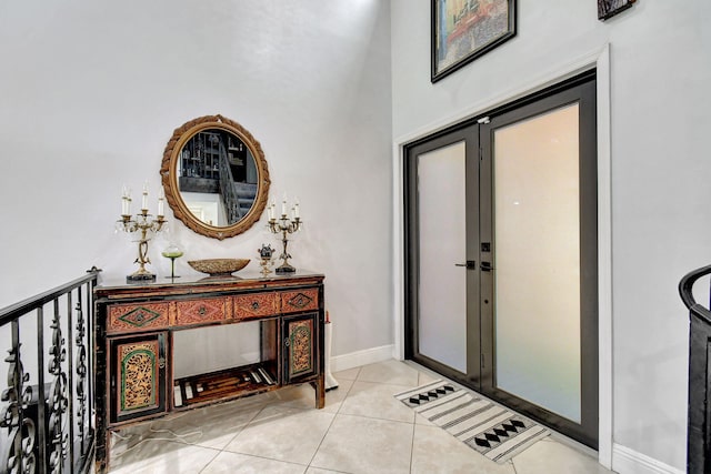 foyer entrance featuring light tile patterned flooring and french doors