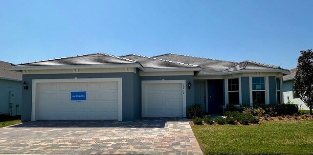 view of front facade with a garage and a front lawn