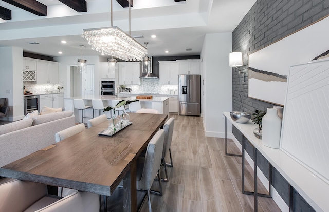 dining room featuring recessed lighting, wine cooler, beam ceiling, and light wood-style flooring