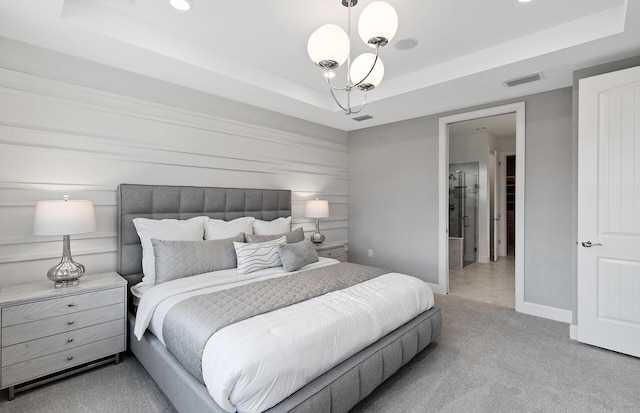 bedroom featuring visible vents, baseboards, a tray ceiling, carpet flooring, and a notable chandelier