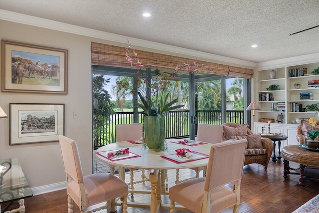 dining area with a textured ceiling, crown molding, and dark hardwood / wood-style floors