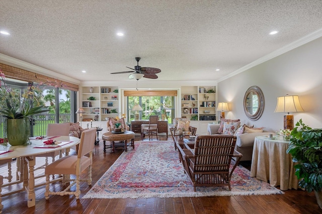 living area with a wealth of natural light, crown molding, a ceiling fan, and wood-type flooring