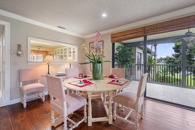 dining space featuring a textured ceiling, crown molding, and hardwood / wood-style flooring