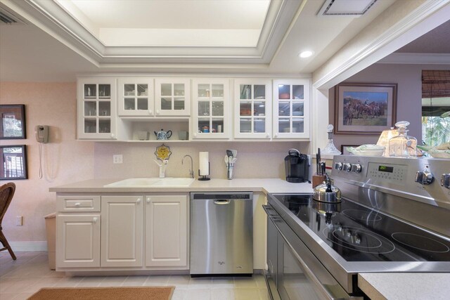 kitchen featuring ornamental molding, white cabinetry, light tile patterned floors, stainless steel appliances, and sink