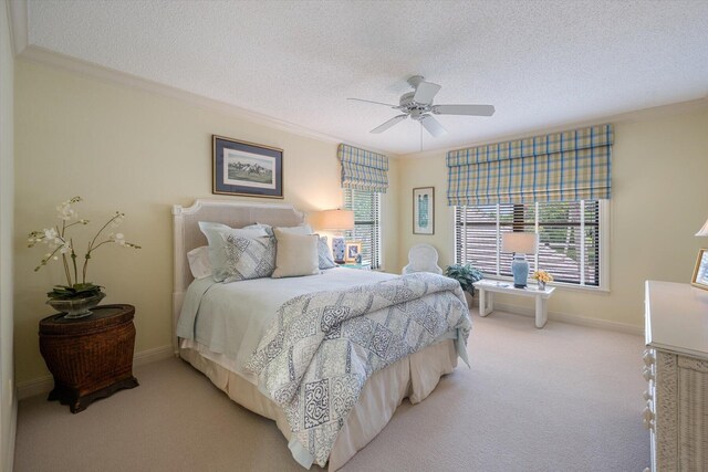 bedroom featuring ceiling fan, ornamental molding, light carpet, and a textured ceiling