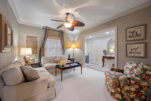 carpeted living area featuring wallpapered walls, crown molding, a ceiling fan, and a textured ceiling