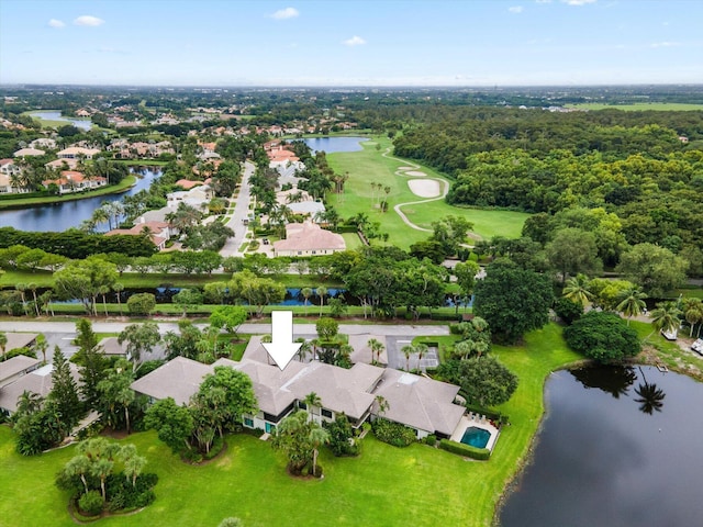 drone / aerial view featuring a residential view, a water view, and view of golf course