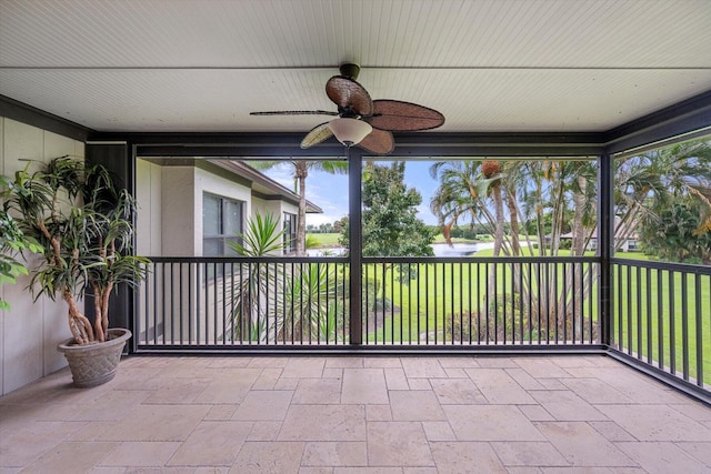 unfurnished sunroom featuring ceiling fan