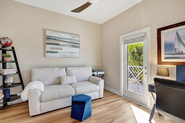 living room featuring ceiling fan and light hardwood / wood-style floors