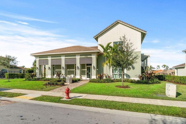 view of front of property with covered porch and a front lawn