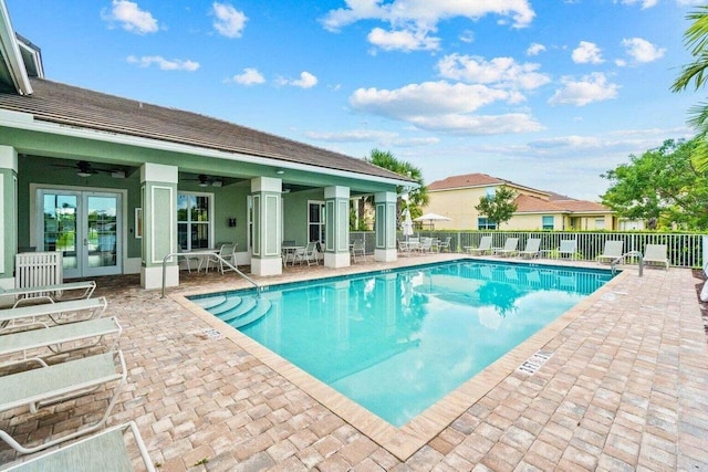 view of swimming pool with ceiling fan and a patio