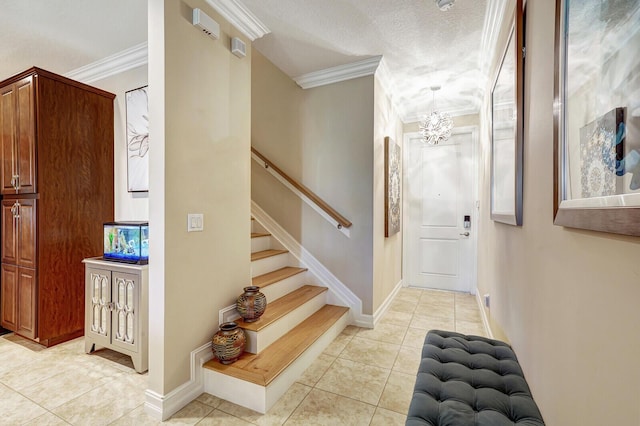 foyer with crown molding, light tile patterned floors, a chandelier, and a textured ceiling