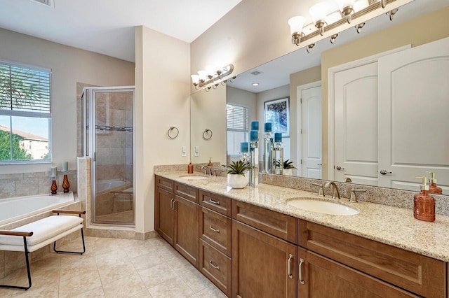 bathroom with tile patterned floors, vanity, and independent shower and bath