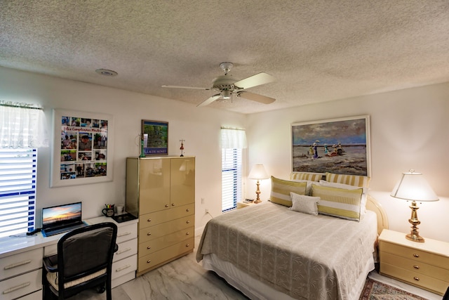 bedroom featuring ceiling fan and a textured ceiling