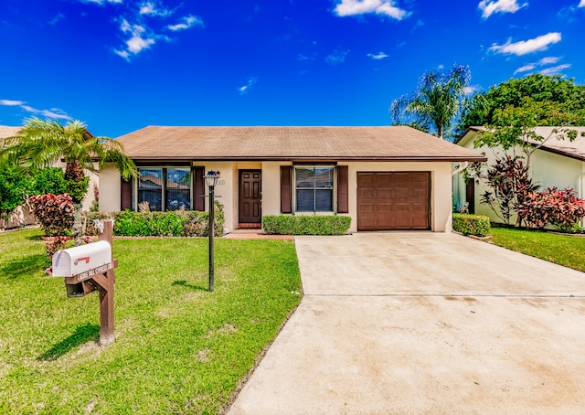 ranch-style house featuring a front lawn and a garage