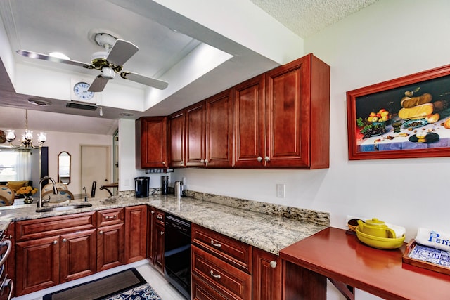 kitchen with light stone countertops, ceiling fan with notable chandelier, sink, and a tray ceiling