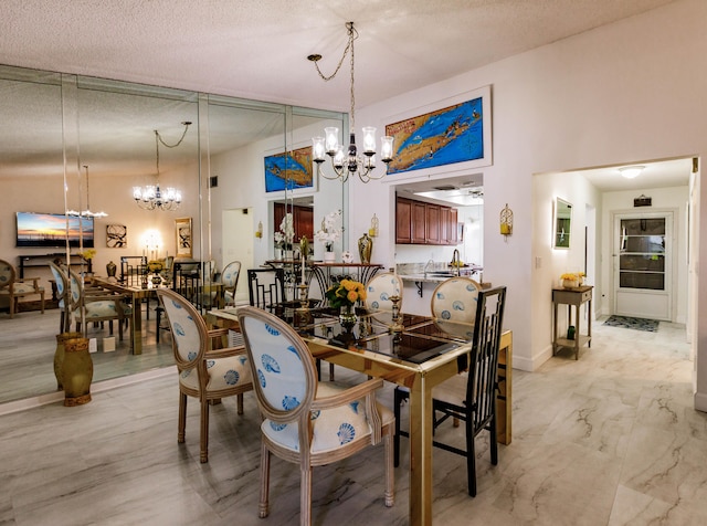 dining area with a notable chandelier and a textured ceiling