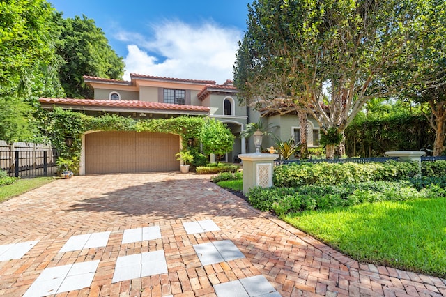 mediterranean / spanish-style house with a garage