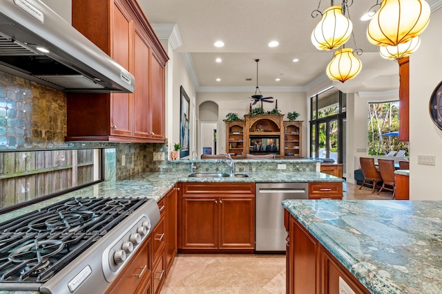 kitchen featuring light stone countertops, range hood, pendant lighting, stainless steel dishwasher, and sink