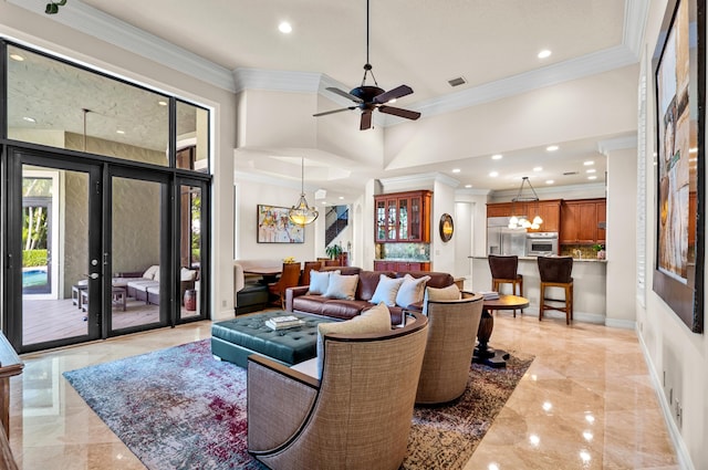 living room featuring ceiling fan with notable chandelier, ornamental molding, and french doors