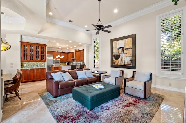 living room with ceiling fan, a wealth of natural light, and crown molding