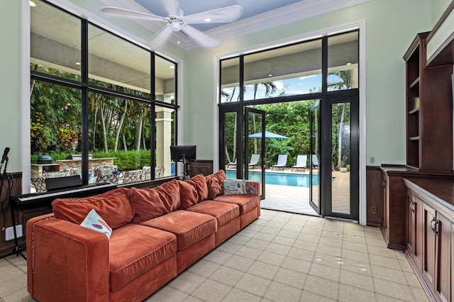 living room featuring ceiling fan and crown molding