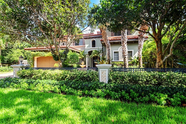 mediterranean / spanish-style home featuring a garage