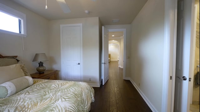 bedroom with ceiling fan and dark hardwood / wood-style floors