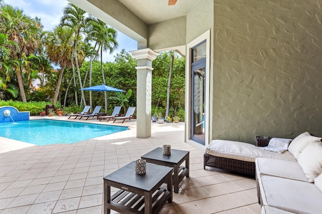 view of swimming pool featuring a patio area, ceiling fan, an outdoor hangout area, and pool water feature