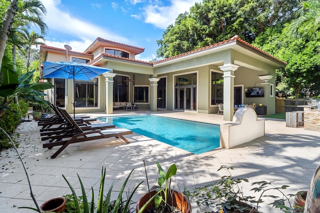 rear view of property with a patio area and a bar