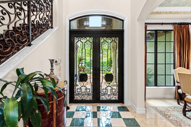 entryway featuring french doors and crown molding