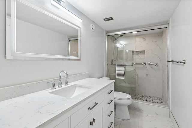 bathroom with vanity, toilet, and a shower with door