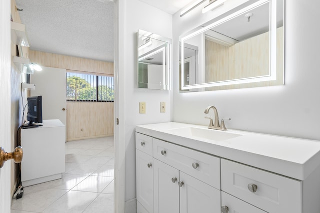 bathroom featuring vanity, tile patterned flooring, and a textured ceiling