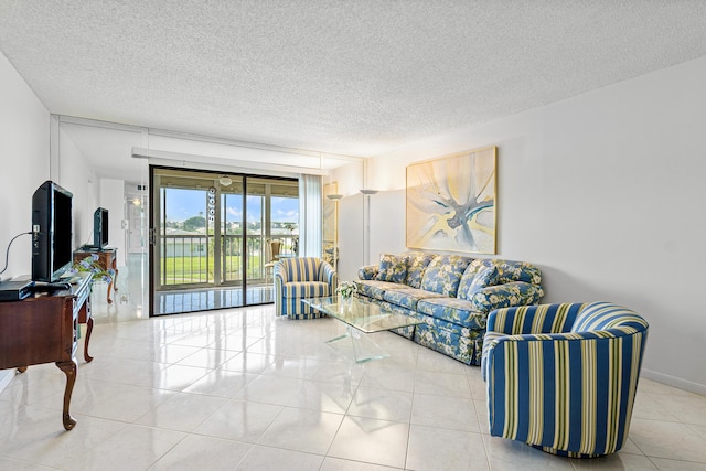 living room with a textured ceiling and light tile patterned floors