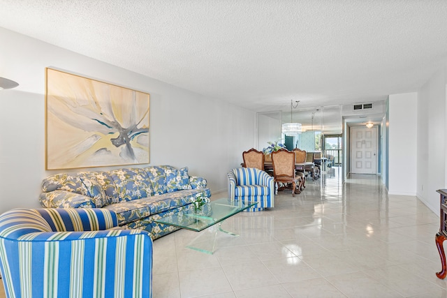 tiled living room featuring a textured ceiling