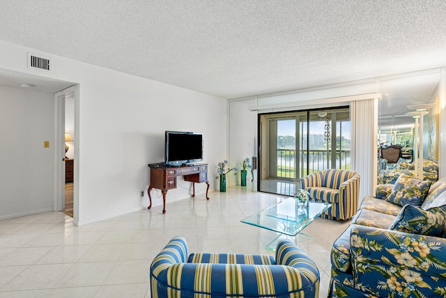 tiled living room with a textured ceiling