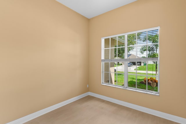 empty room featuring plenty of natural light and hardwood / wood-style floors