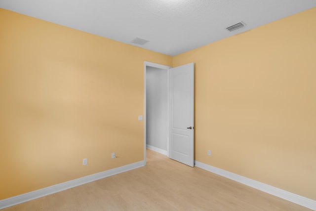 spare room featuring light wood-type flooring