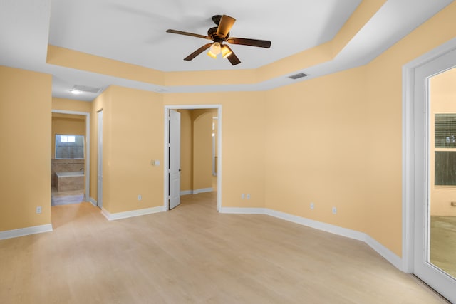 interior space featuring ceiling fan, light wood-type flooring, and connected bathroom