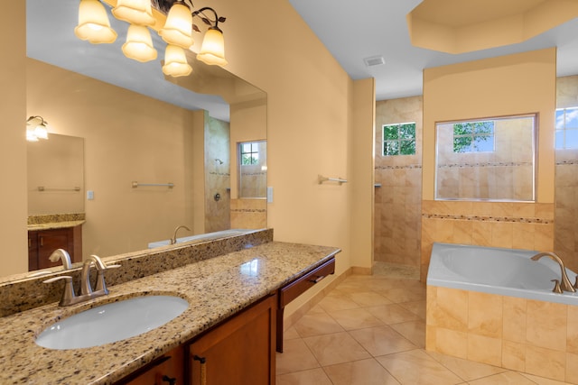 bathroom featuring vanity, independent shower and bath, and tile patterned floors